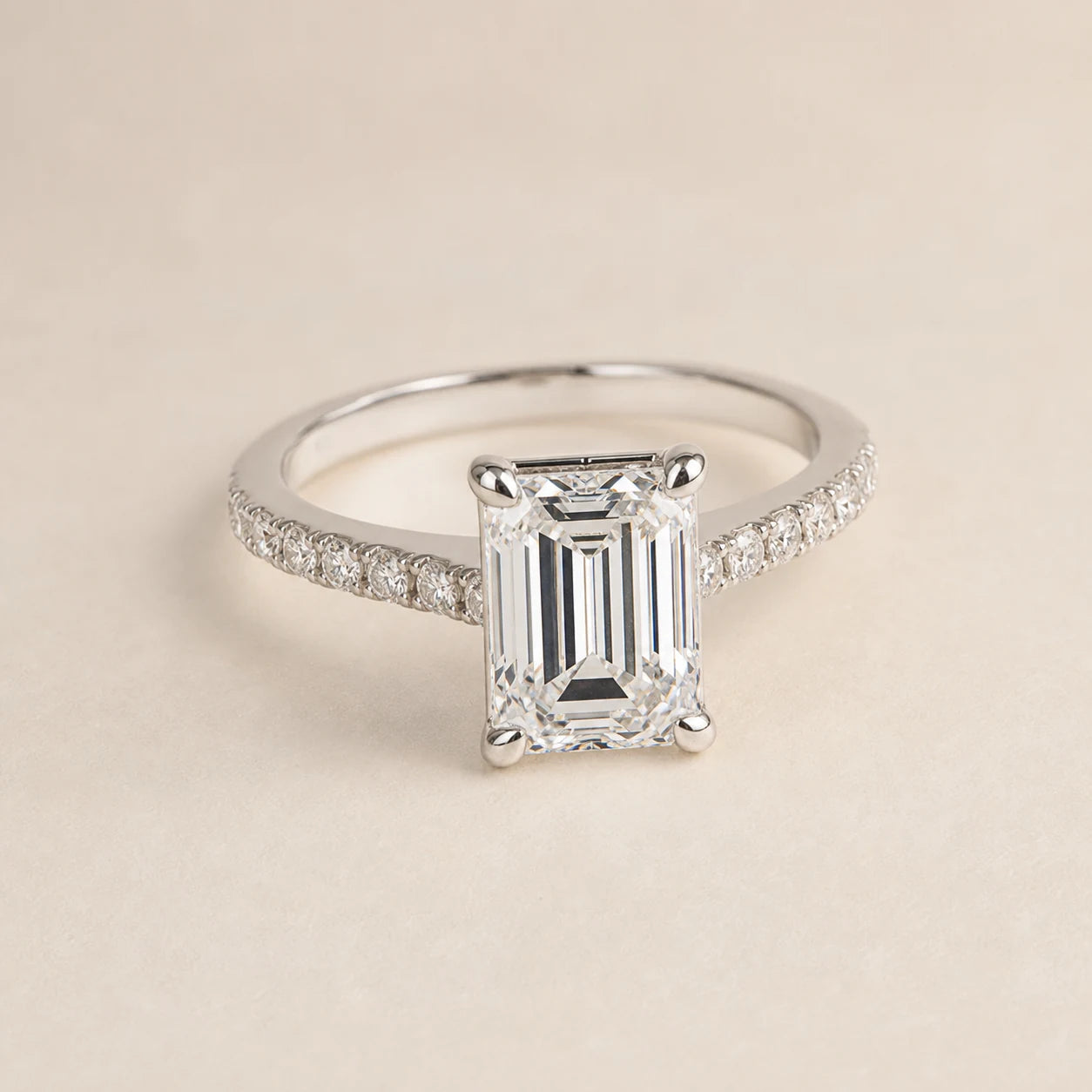 Emerald-cut lab-grown diamond engagement ring with a white-gold cathedral pave band
