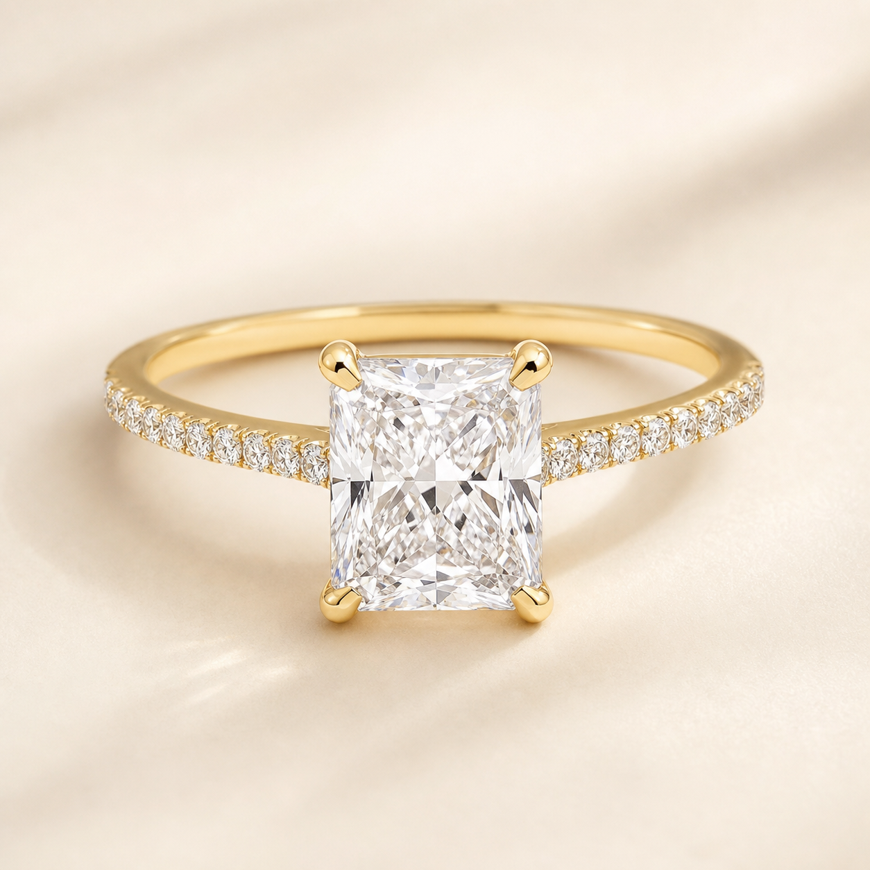 Radiant lab-grown diamond engagement ring with a yellow-gold petite pave band