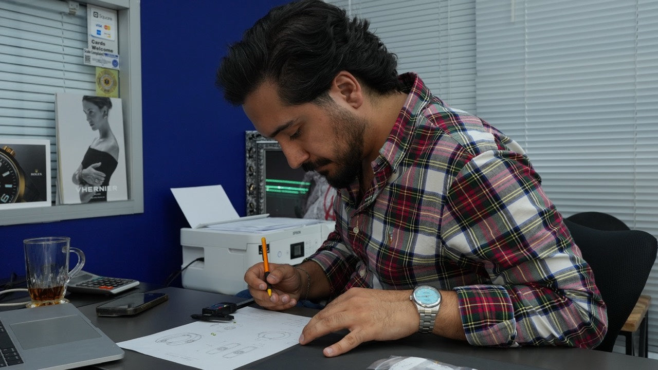 Fere jeweler sketching a custom jewelry design at the workbench