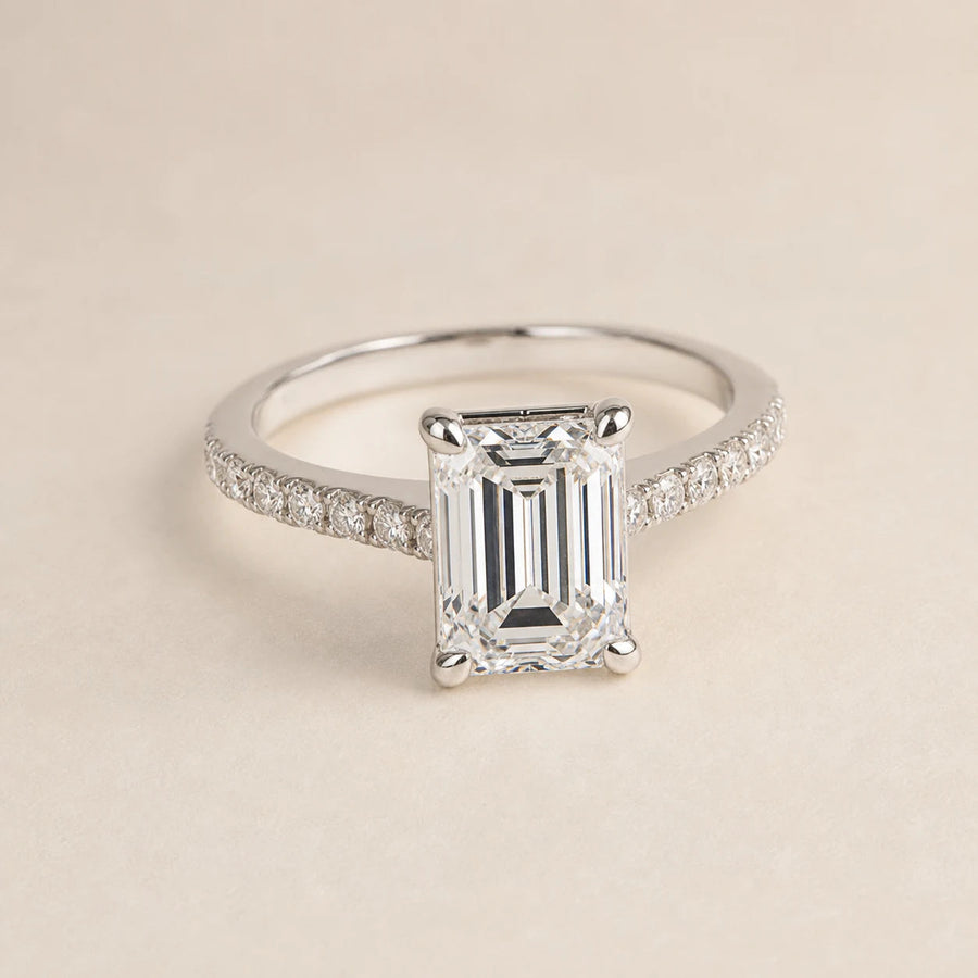 Emerald-cut lab-grown diamond engagement ring with a white-gold cathedral pave band
