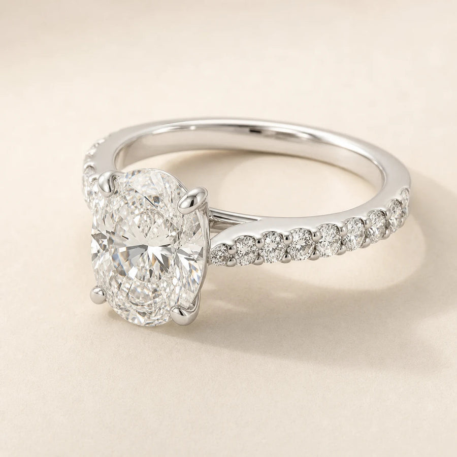 Oval lab-grown diamond engagement ring with a white-gold shared-prong diamond band
