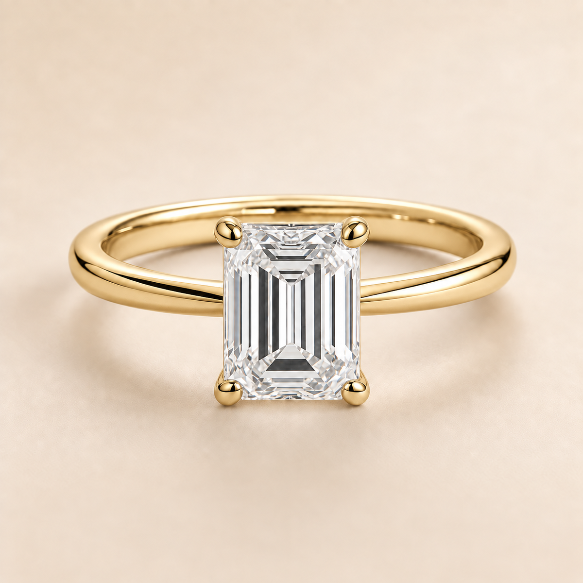 Emerald solitaire engagement ring in Yellow Gold — front view