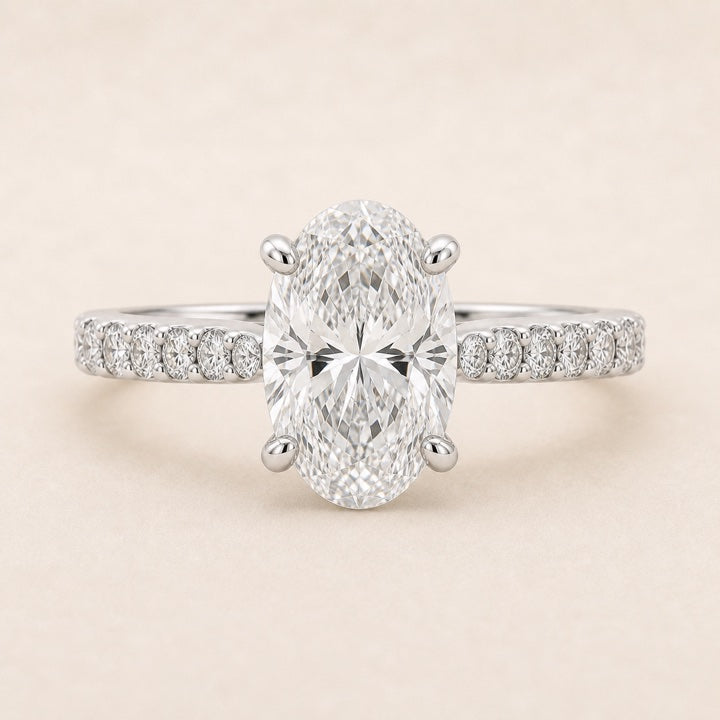 Front-facing Mirelle oval-cut lab-grown diamond engagement ring with a shared-prong pavé band.